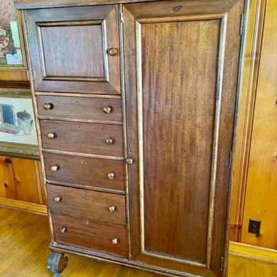 Lot 075-LR: Antique Wardrobe

Features: 
â€¢	Antique wardrobe with 5 drawers
â€¢	On metal wheels
â€¢	No key available

Dimensions: 44â€W...