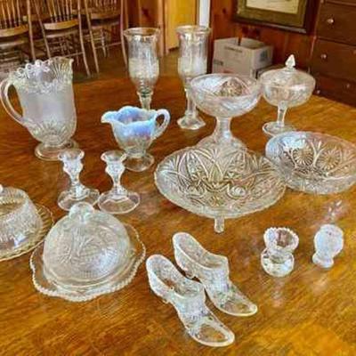 Lot 058-LR: Clear Glass

Features: 
â€¢	16 pieces
â€¢	Includes 2 plates with domes, 1 pair of candlestick holders, 1 pair of glass...