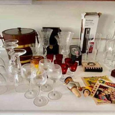 Lot 121-K: Barware and Stemware Collection

Includes: 
â€¢	More than 3 dozen pieces of stemware
â€¢	Three 1970s-era mixology manuals and...