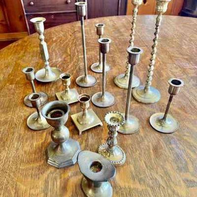 Lot 079-LR: Brass Candlestick Collection

Features: 
â€¢	15 Brass candlesticks in total
â€¢	Various sizes, some pairs

Dimensions:
â€¢...