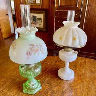 Lot 101-BR1: Electrified Lamp Pair #3

Features: 
â€¢	Electrified oil lamps with hand-painted floral shades
â€¢	One green glass base has...