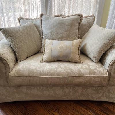 rolled arm loveseat with ivory upholstery 