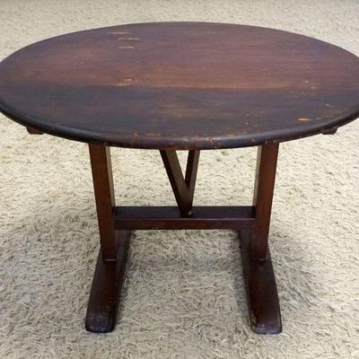 1027	SMALL PRIMITIVE PINE OVAL TILT TOP TABLE ON TRESTLE BASE W/MORTISE & TENON CONSTRUCTION, APPROXIMATELY 30 IN X 24 IN X 21 IN HIGH
