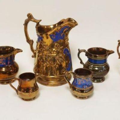 1062	GROUP OF 8 ASSORTED ANTIQUE COPPER LUSTER PITCHERS, TALLEST APPROXIMATELY 9 1/2 IN HIGH
