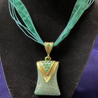 pendant on blue ribbon chain