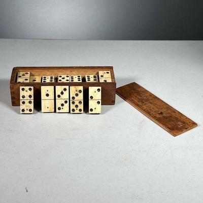 ANTIQUE BONE DOMINOES | Carved bone domino set in original wooden box.