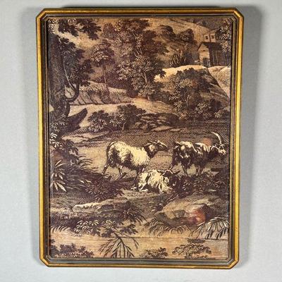 EMBROIDERED FARM SCENE | Showing goats among rolling hills and floral & fauna, with a small farmhouse in background; in a gilt frame.