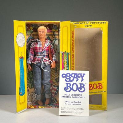 GAY BOB DOLL | Gay Bob doll in original packaging with original clothing fashion catalog. Dimensions: l. 2.5 x w. 5.5 x h. 13 in