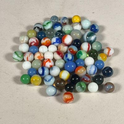 GLASS MARBLES | An assortment of colored glass marbles.