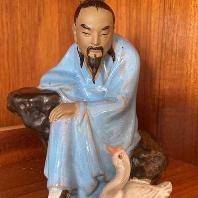 Asian Mudman Sitting With Goose Figurine