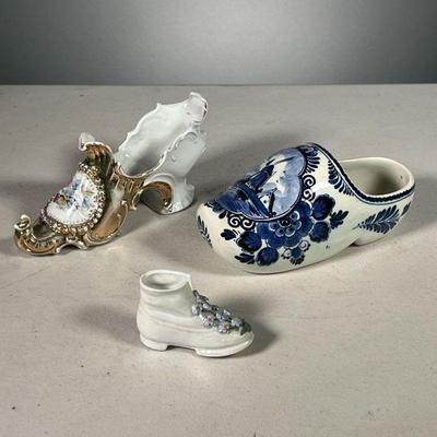 (3PC) DELFT & OTHER PORCELAIN SHOES | Including a Delft blue and white shoe (l. 6.5 in.), an unmarked pointed porcelain shoe with gilt...