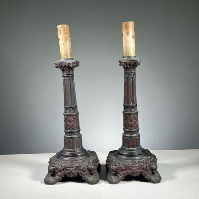 (2PC) PAIR OF PAINTED CAST IRON LAMPS | Red painted cast iron lamps electrified with cardboard candle sleeve on top. Dimensions: l. 6 x...