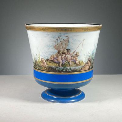 VIENNA PORCELAIN CACHEPOT | Porcelain planter, gilt rim, decorated with cupids in nature scenes. Dimensions: h. 8.5 x dia. 8.5 in