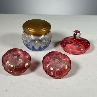 (4PC) ASSORTED GLASS TRINKETS | Includes pair of pink flowers from Czechoslovakia, a red lid with blue polka dots, and a blue jar with lid.