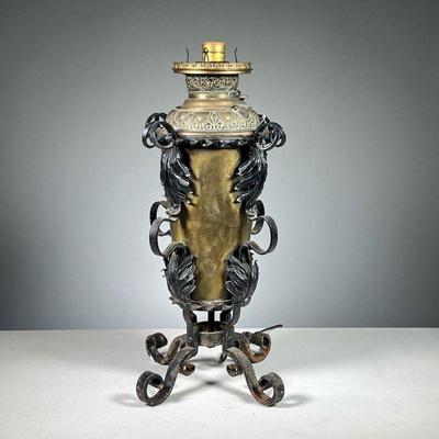 ANTIQUE BANQUET OIL LAMP ELECTRIFIED | Electrified brass banquet lamp with wrought iron frame and legs. Dimensions: l. 8 x w. 8 x h. 19.5 in