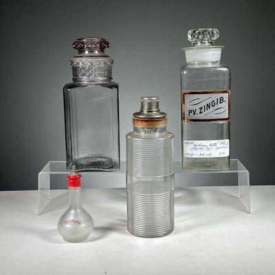 (4PC) LARGE GLASS CONATINERS | Includes: blown glass apothecary bottle with top, a similar square bottle with a patterned top, a circular...