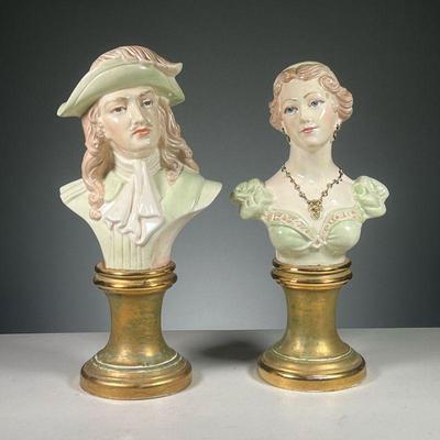 (2PC) PAIR OF PAINTED BUSTS | Featuring man and woman pair with gold and green necklace and earring set on pedestals .