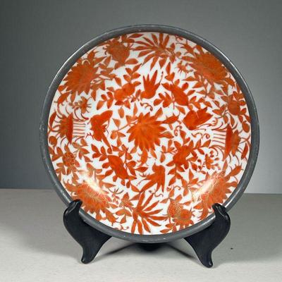 CHINESE IRON & PORCELAIN BOWL | Porcelain bowl with orange decoration of flowers and butterflies with gilt highlights, reinforced with an...
