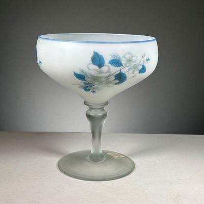 PHOENIX GLASS COMPOTE | White glass compote with blue rim and floral decoration painted around bowl, on a frosted glass pedestal base....