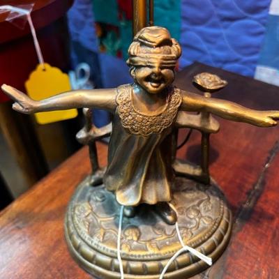 Bronze girl playing blind manâ€™s bluff.