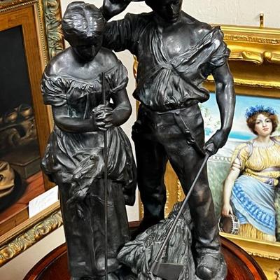 Bronze couple reaping in the field Vic