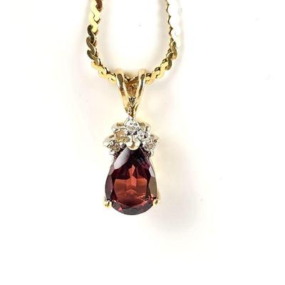 14k Gold Chain and Garnet Pendant Encased in 14k Gold and Small White Diamonds. 14