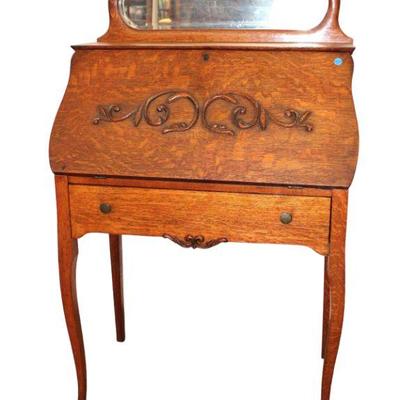 
Lot 355
Antique oak ladies slant front desk with bevel glass mirror backsplash
