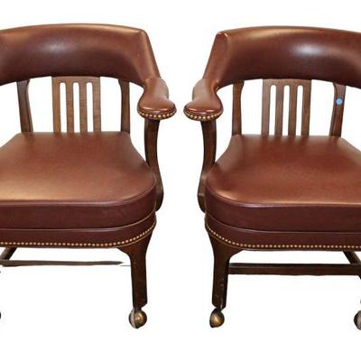 
Lot 370
Pair of leather style industrial tacked arm chairs on rollers
