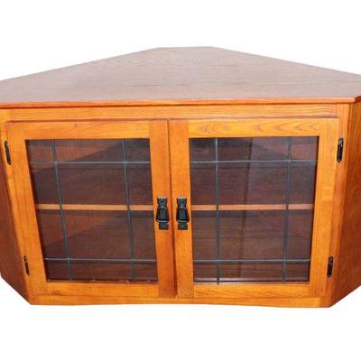 
Lot 214
Contemporary oak corner TV stand with leaded glass doors

