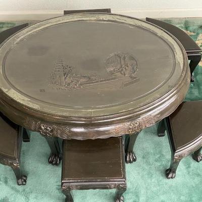 Chinese Wood Carved Oval Glass Topped Tea/Coffee Table with 6 Stools. Carved Dragons on edge.