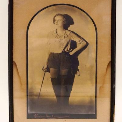 1074	PHOTO OF ACTRESS W/SWORD & BOOTS PIRATE, APPROXIMATELY 12 IN X 18 IN, SOME WATER STAINING
