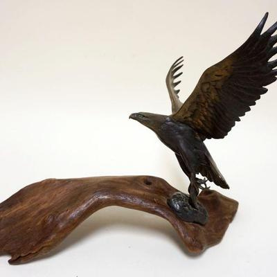 1129	BRONZE EAGLE ON WOOD BASE, APPROXIMATELY 15 IN X 11 1/2 IN HIGH
