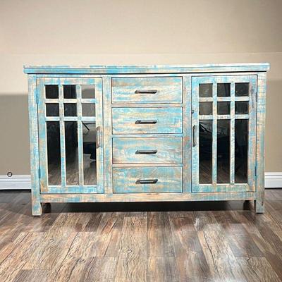 CABINET IN DISTRESSED BLUE FINISH | Wood cabinet with two mirrored cupboard doors each with one shelf, centering four drawers. - l. 56 x...