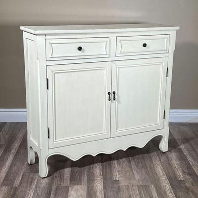 WHITE SOLID WOOD CABINET | White painted wood having two drawers over double cabinet doors, with a scalloped apron. - l. 40 x w. 11 x h....