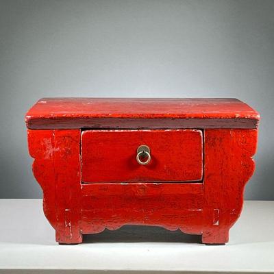 CHINESE LACQUER STOOL | Red lacquered low form stool with shaped front and a single drawer. - l. 22.5 x w. 15 x h. 12.5 in