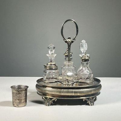 SILVER PLATED CONDIMENT SET | With six glass bottles in a reticulated stand, marked 