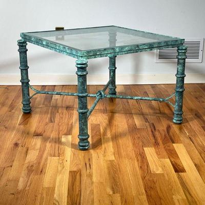 VERDIGRIS LOW TABLE | Green patina frame, having a beveled glass top and an X-form stretcher. - l. 31 x w. 31 x h. 21 in