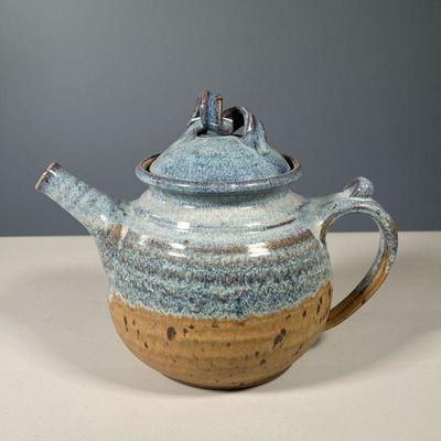 EARTHENWARE BLUE GLAZED TEAPOT | Heavy blue glazed earthenware teapot, twist motif lid, signed by artist on the bottom - w. 10 x h. 8 in