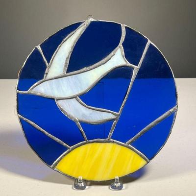 STAINED GLASS DECORATION | Hand wrought stained glass window hanging with a bird and sun. - dia. 10 in