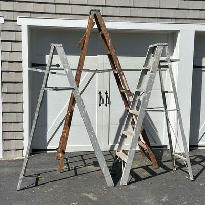 (3PC) LOT OF LADDERS | Two 6-foot aluminum painters ladders and one 8-foot wood ladder.
