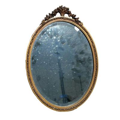 GILT MIRROR | Round gilt mirror with aged glass; basket motif on top. - l. 16.5 x w. 12 in
