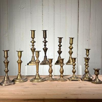 (13PC) BRASS CANDLESTICKS | (13) Brass candlesticks (3) Pairs, (7) are singles. - h. 10 in (Tallest)
