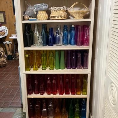 A rainbow of glass bottlesâ€”for a bottle tree maybe? (Weâ€™re selling three trees!)