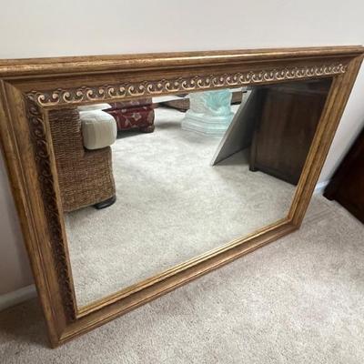 Mirror with gold toned frame for vertical or horizontal orientation. 