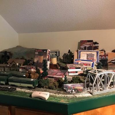 Lionel train set, 30 pieces, engines plus buildings, includes about 60 pieces of track, trees landscapes and buildings, on a train table...