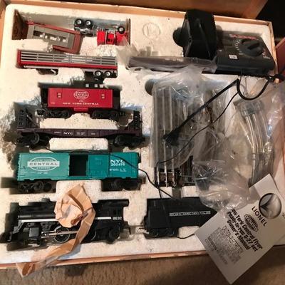 Lionel train set, 30 pieces, engines plus buildings, includes about 60 pieces of track, trees landscapes and buildings, on a train table...