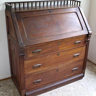 Antique slant front walnut desk with brass pulls - closed