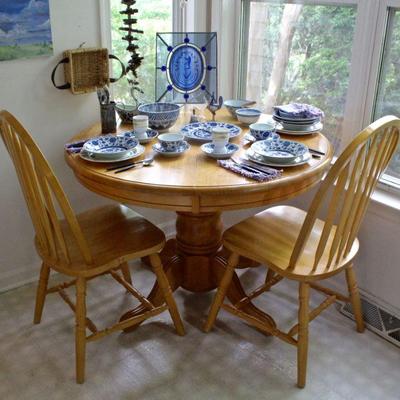 round oak table with two Windsor style chairs, mix and match china including blue & white and Wedgwood, silverware, colored & clear glass...