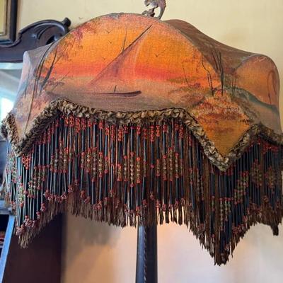 Fantastic antique floor lamp with elaborate decorated shade with long bead fringe, featuring a coastal water scene with a sailboat and birds
