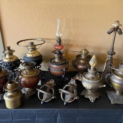 Antique kerosene lamps, electric lamps, and candelabra from varying makers. Dated from 1800s to circa 1920s. 